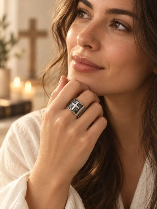 Woman wearing a Yeneast vintage silver-tone Christian cross signet ring with a bold engraved design.