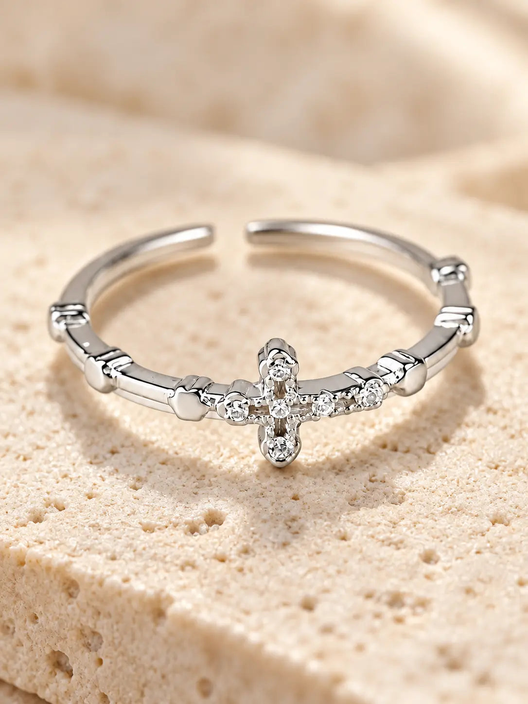 Close-up of Yeneast dainty crystal cross open ring showing sparkling stones, polished finish and adjustable open band design.