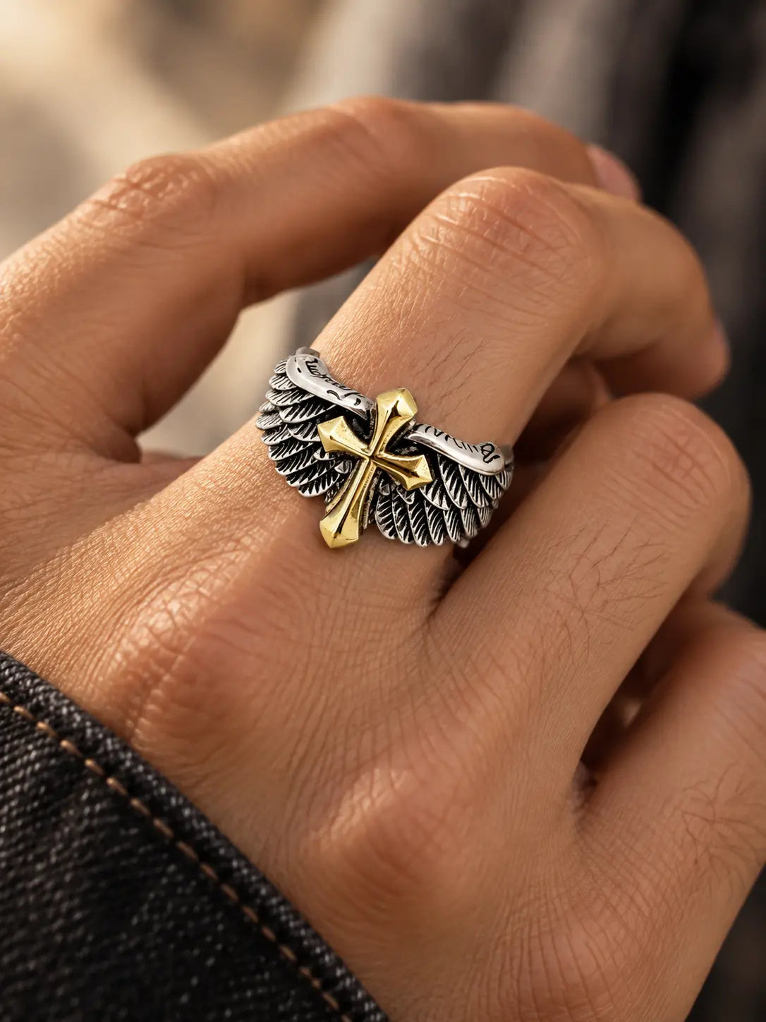 Model wearing the Gothic Angel Wing Cross Ring, a bold Christian faith ring with silver wing detailing and a gold cross.