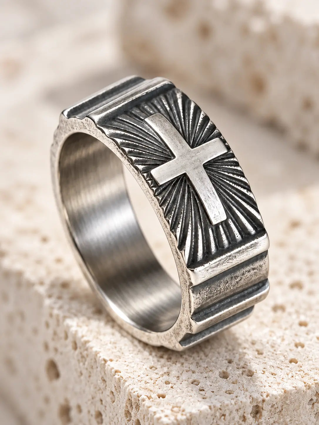 Close-up of Yeneast Christian cross signet ring showing the raised cross, oxidized finish and detailed sunburst engraving.