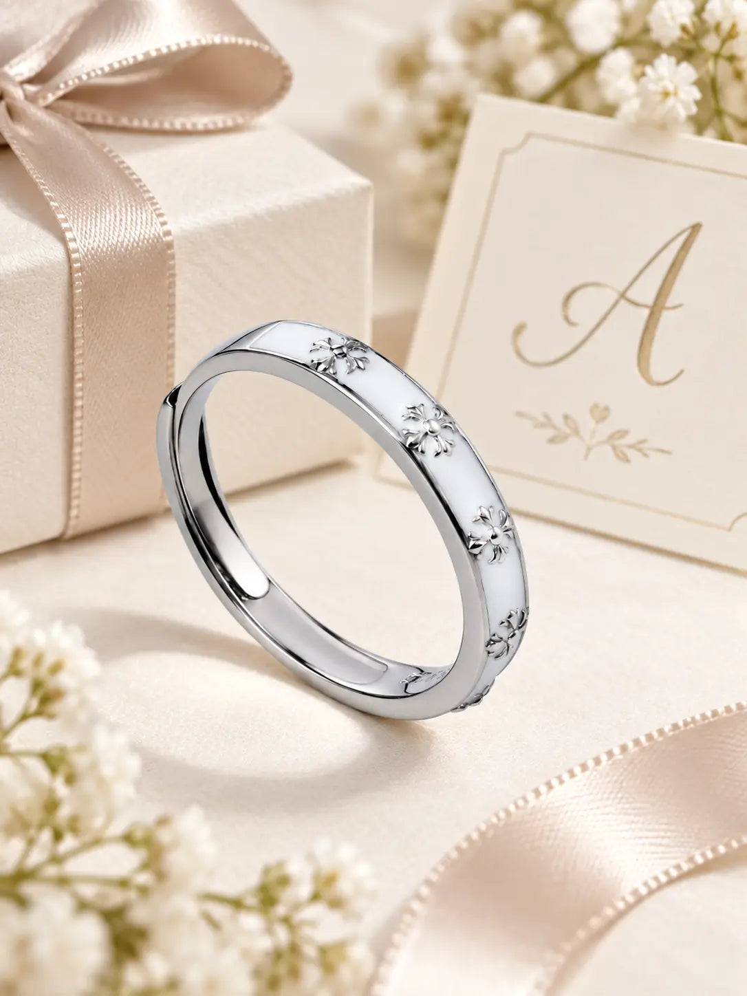 YENEAST crystal cross hoop earrings in silver and gold displayed on a cream jewelry gift tray with ribbon and initial cards