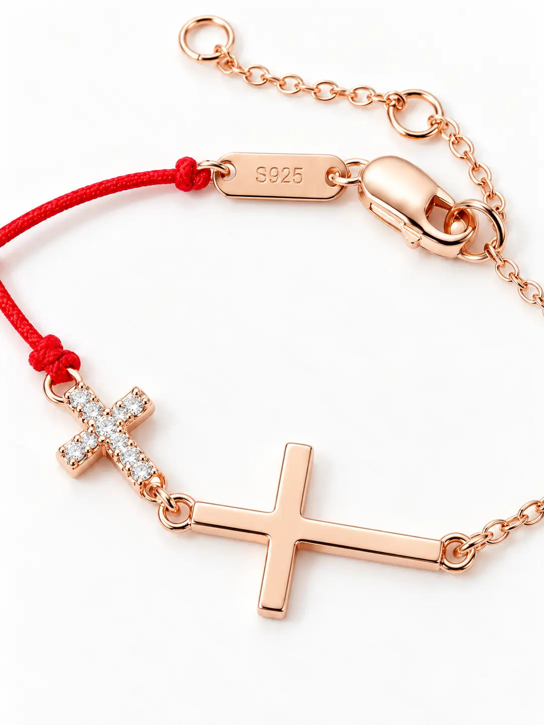 Close-up of the YENEAST red cord cross bracelet showing the cubic zirconia cross, sterling silver craftsmanship and red cord detail