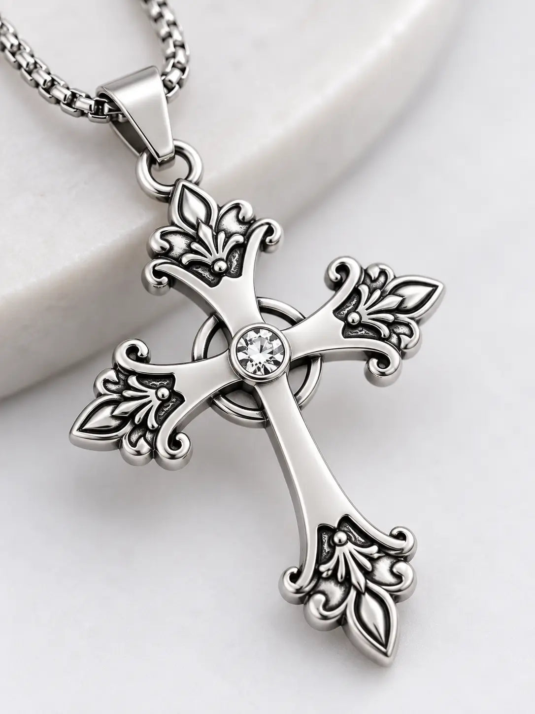 Close-up of the YENEAST vintage ornate cross necklace showing decorative tip details, clear center crystal and polished silver-tone finish