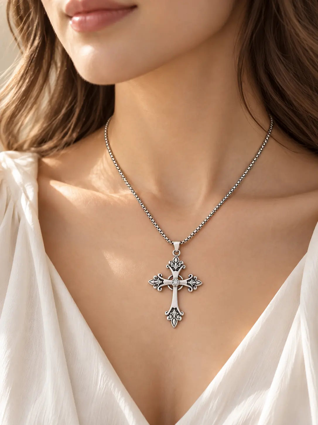 Woman wearing the YENEAST vintage ornate crystal cross necklace in silver tone as everyday Christian jewelry