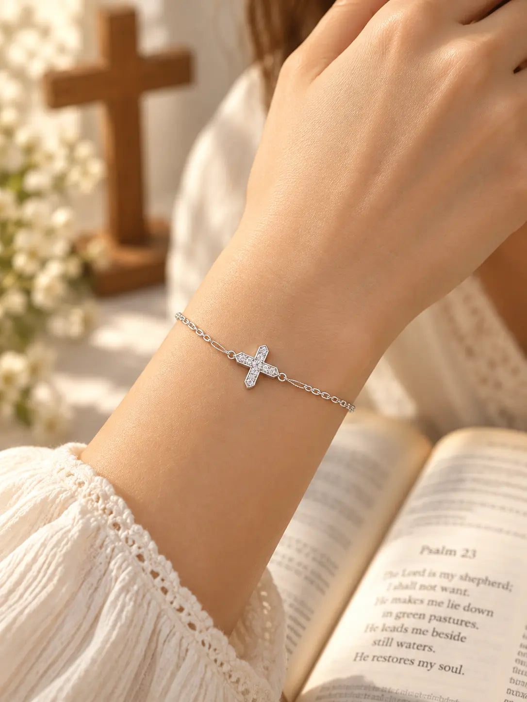 Model wearing the Zircon Cross Bracelet, a delicate silver Christian faith bracelet with a sparkling crystal cross charm.